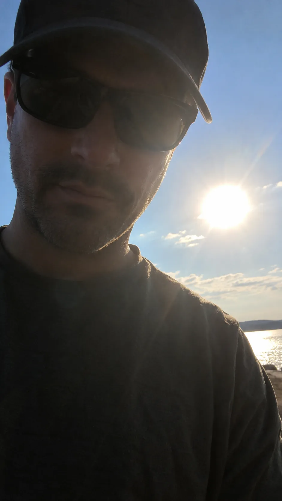 Sample photo: a man in sunglasses and a cap, half in shadow